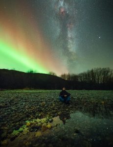 Adrien Mauduit and the night sky with northern lights and stars.