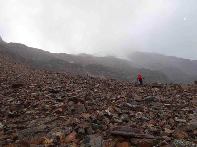 Walking up scree as the cloud and snow came in. 