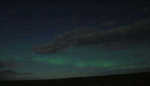 Northern Lights over Orkney on a cloudy, moonlit night.