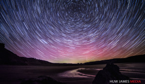 Startrails over Wales with the aurora behind.