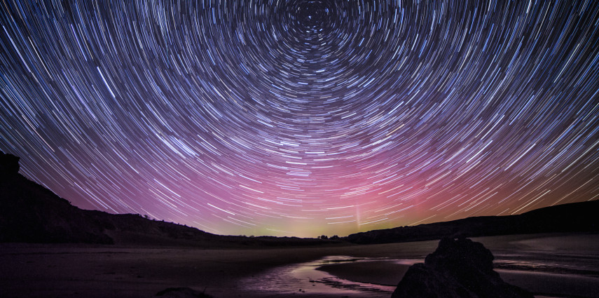 Startrails over Wales with the aurora behind.