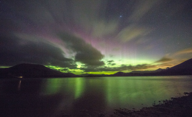 Aurora over Papanui Inlet, New Zealand, with the clouds coming in.